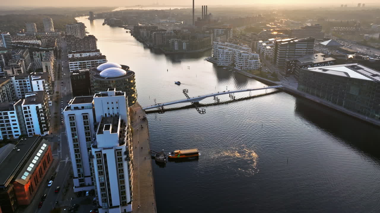 Aerial drone view of the Islands Brygge harbourfront area in central Copenhagen, Denmark at sunset