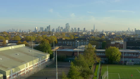 descending aerial shot of london skyline into north london suburbs