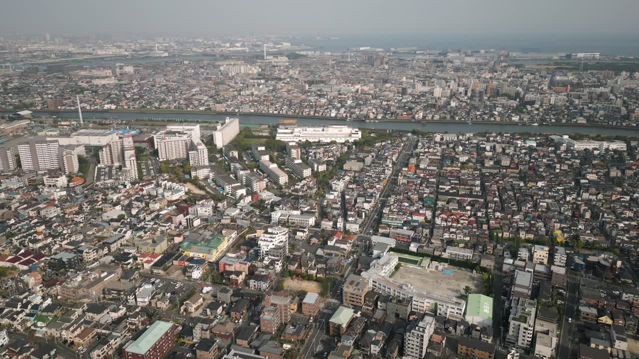 Aerial Scenic Urban Drone Footage of a neighborhood, streets and buildings in the Capital City of Tokyo, Japan during Sunset