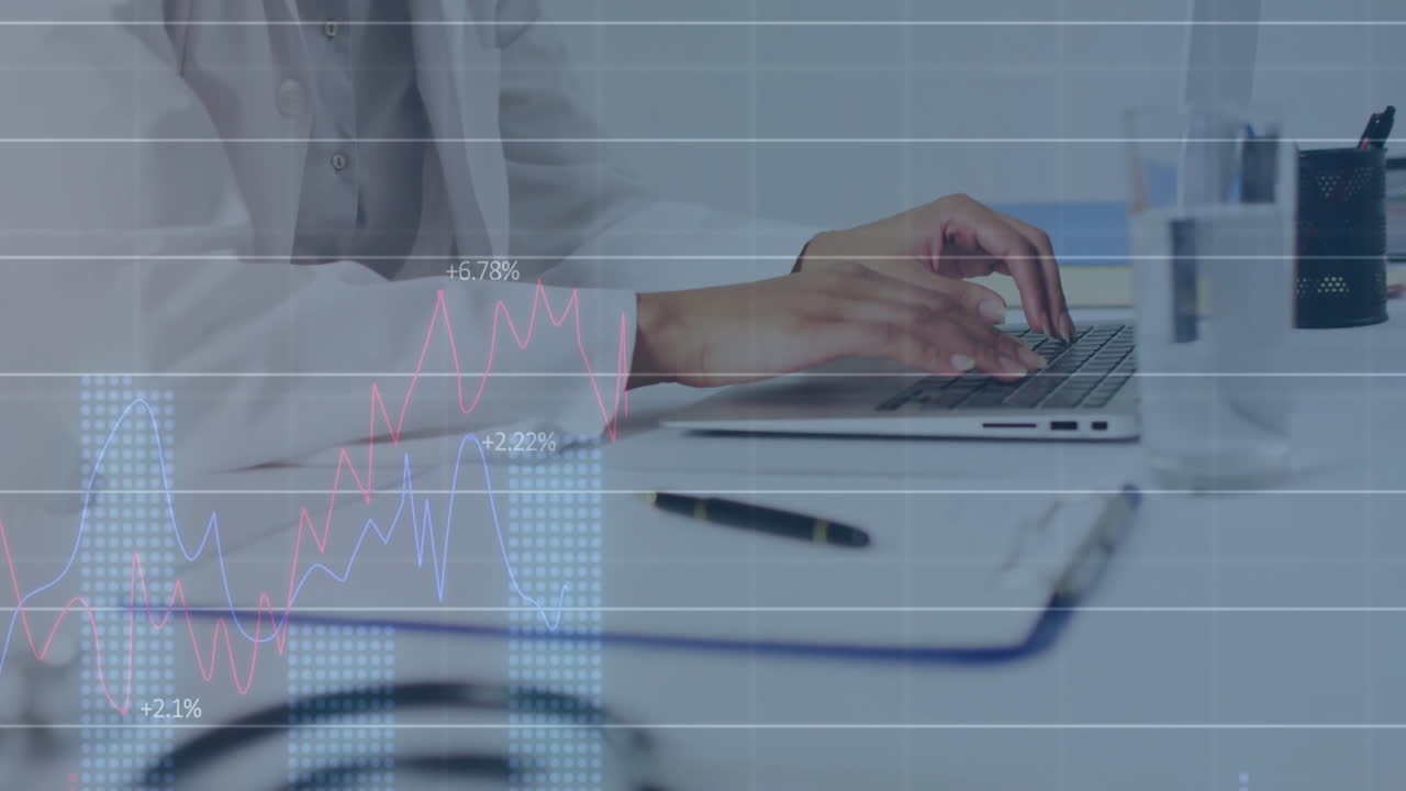 Medical professional typing on laptop tracking finance charts over clinical desk with stethoscope