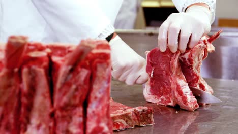 mid section of butcher slicing meat