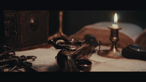 an someone puts and old pistol on the table filled with documents and maps inside the sailing ship cabin