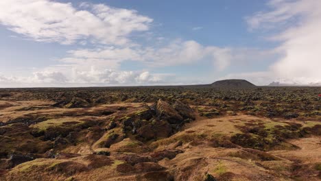 wide aerial view over mossy lava fields near búðir, snæfellsnes peninsula, iceland. volcanic textures and open skies define this dramatic, untouched icelandic terrain.