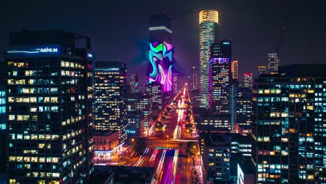 night cityscape of tel aviv with illuminated buildings and projection mapping