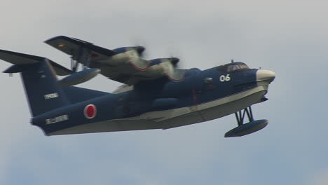 fly-by of a japanese us-2 amphibious plane from close up to wide angle