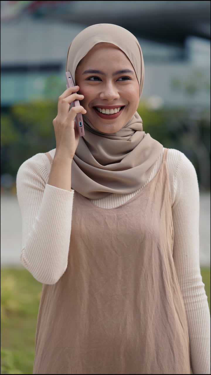 Woman wearing hijab talking on the phone