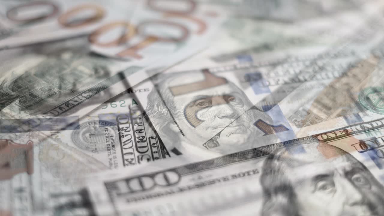 Heap of hundred dollars banknotes, double exposure circle rotation close up