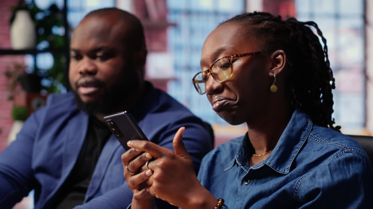 Black couple sitting together at home office and managing their affairs