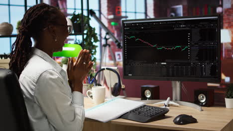 happy day trader using pc, satisfied after purchasing well performing stocks