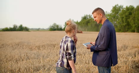 agriculture farmer talking with businessman at harvesting 8