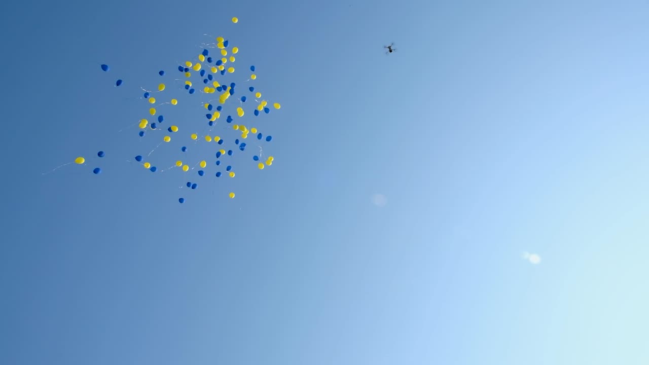 노란색과 파란색 풍선이 하늘을 날다