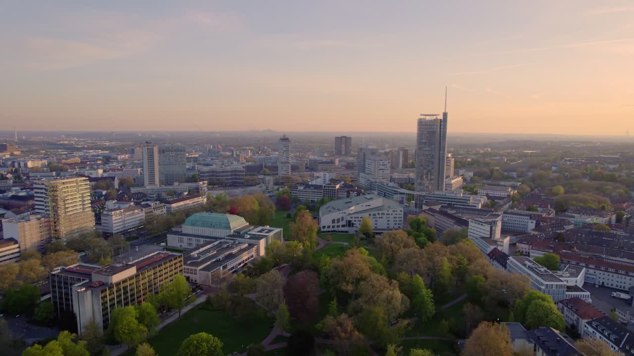 Aerial view of Essen city in Germany with reddish sky. Sudviertel district in Essen, Germany. panoramic landscape of Europe from above. The city skyline under the sunset.