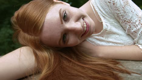 Happy-smiling-teen-woman-in-park,-looking-to-camera-like-on-her-boyfriend