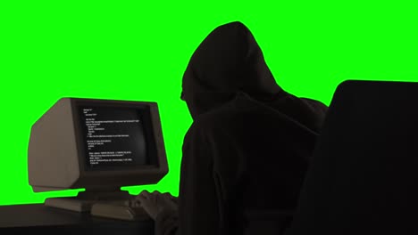 hooded hacker attacks data server from a computer