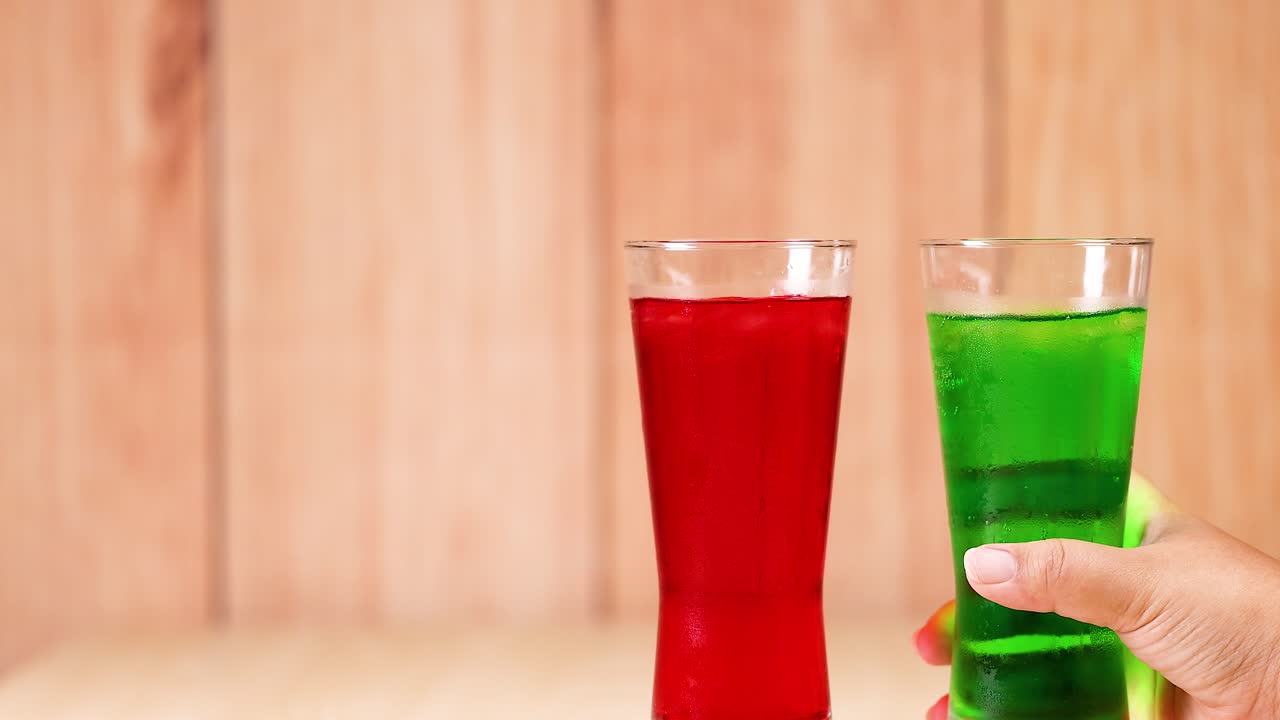 Two glasses clinking in a celebratory gesture