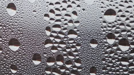 water droplets on foggy window glass, background, extreme closeup