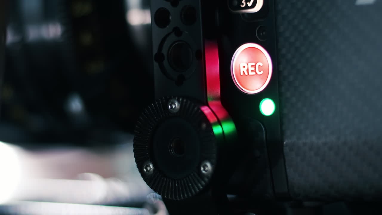 Glowing Record buttons on a professional video camera on the movie set