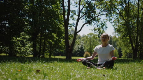 woman meditating in a park