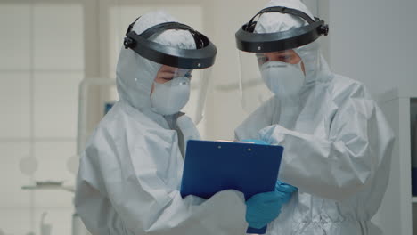 Close-up-of-dentistry-doctors-talking-wearing-hazmat-suit