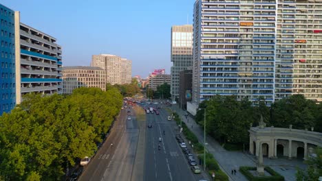 Berlin cityscape with residential buildings, a coca cola billboard, and cars moving along the streets. Spectacular aerial view flight overflight flyover drone