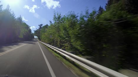 view from a car driving on a small countryside road