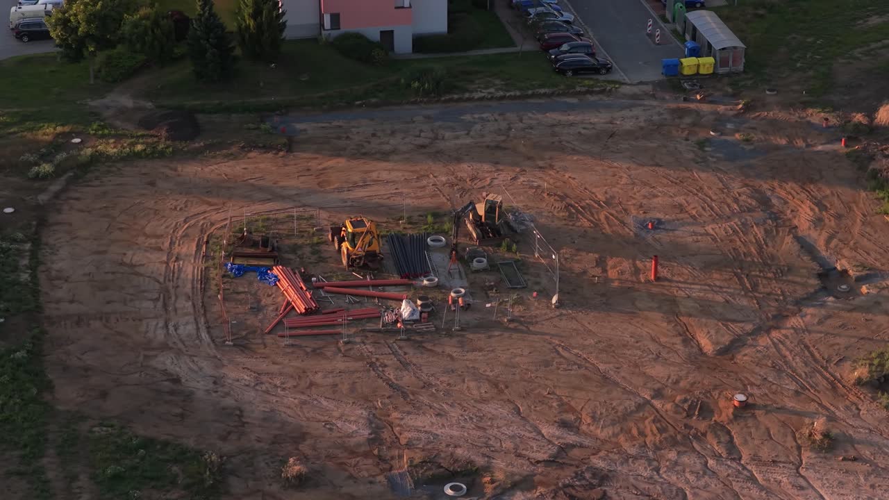 Abandoned excavators on a construction site. Workplace with building materials from a drone perspective