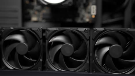 close-up of spinning computer fans inside a pc case