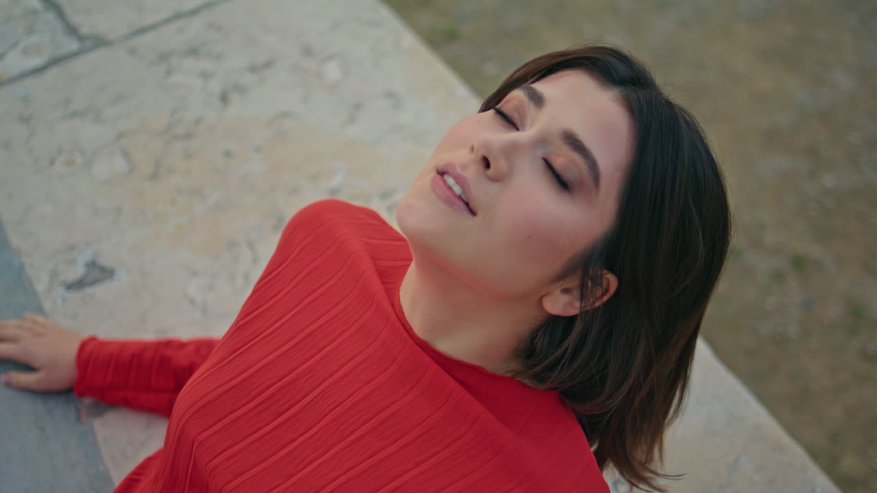 Fashion lady posing city leaning fountain border portrait. Woman looking camera