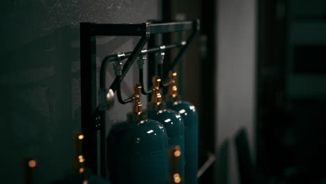 close-up of industrial gas cylinders on a metal rack