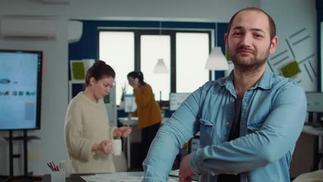 Portrait-of-confident-man-entering-frame-posing-with-arms-crossed-and-smiling