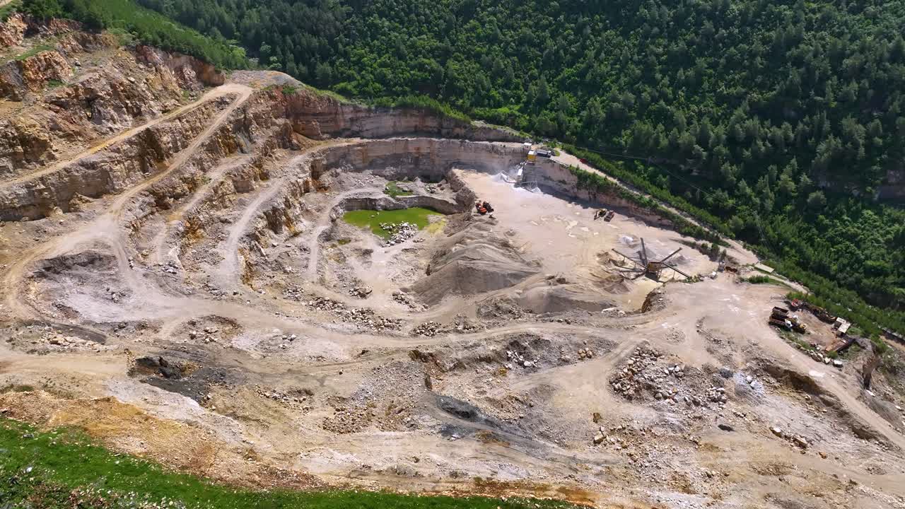 Stone quarry dug on hillside and deforestation around