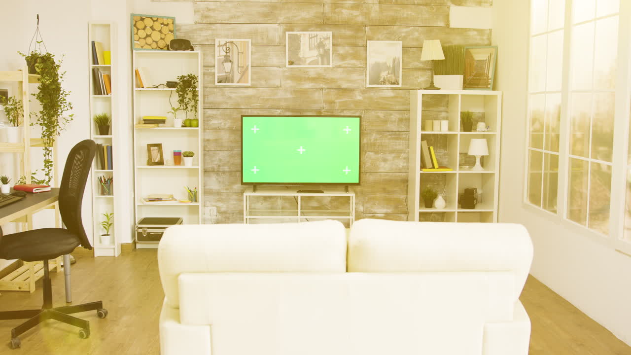 Living room with green screen TV and modern decor