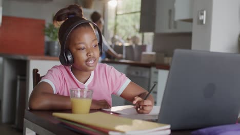 african american girl using laptop for online lesson, slow motion