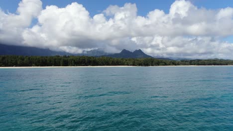 Langsamer-Drohnenflug-über-Den-Ozean-In-Richtung-Land-Und-Die-Wunderschöne-Landschaft-Dahinter