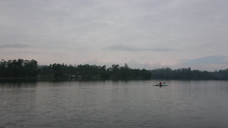 Canoeists-enjoy-paddling-on-a-lake-surrounded-by-forests-and-mountains