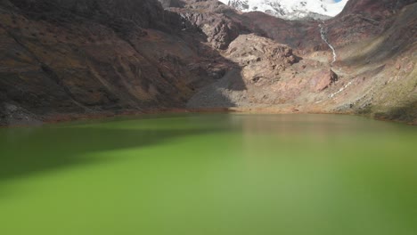 smooth fly over the green lake peruavian andes