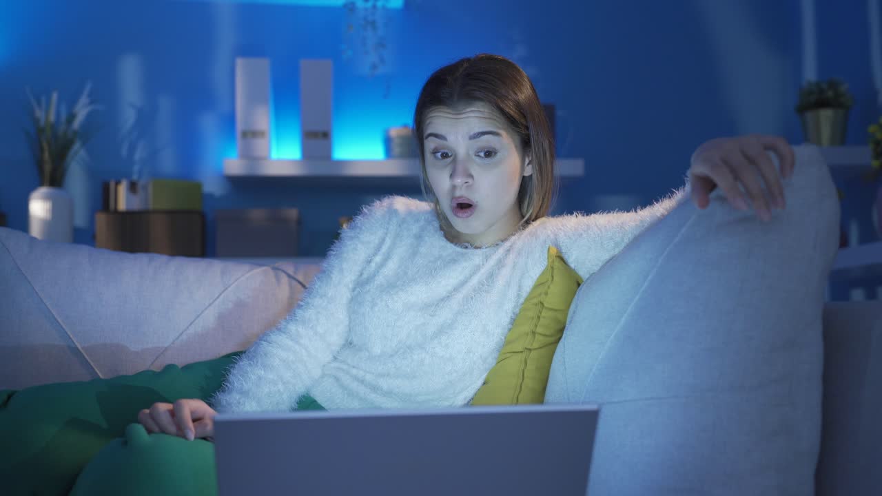 The young woman who watches science fiction and documentaries watches in amazement.