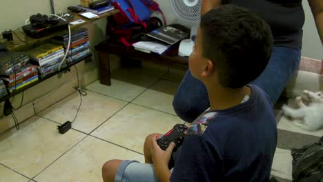 young boy playing video games at home