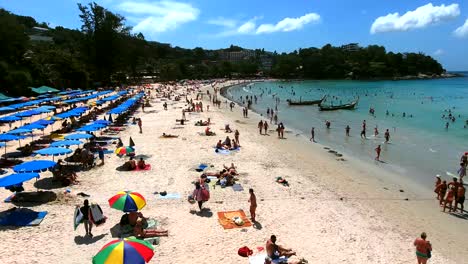 phuket, thailand - 20 jan 2017: aerial view of people swim in sea near beach with sunbeds and parasols at summer sunny day