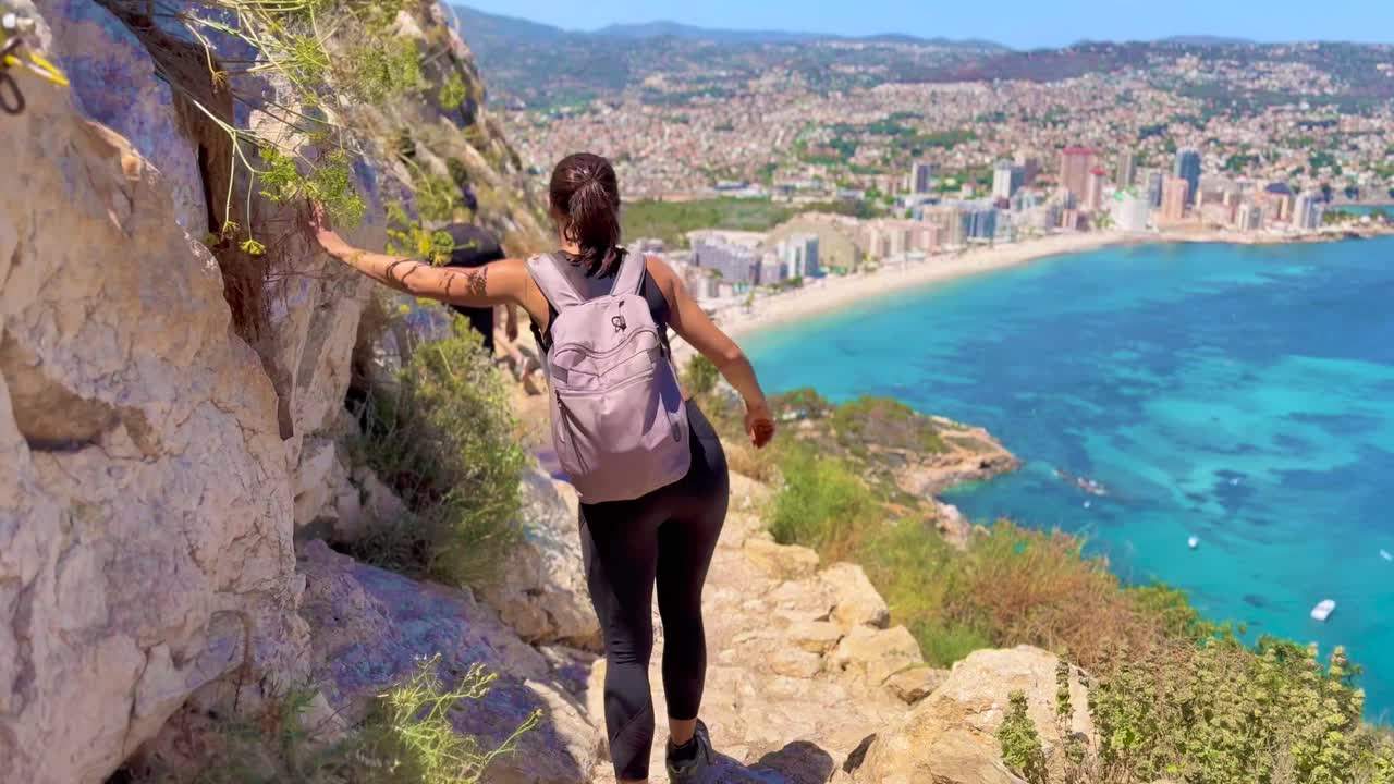 Young Female Hiker Reaching the Summit of Penon de Ifach with Coastal Views