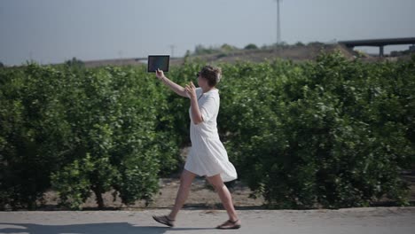 woman taking a selfie in an orchard
