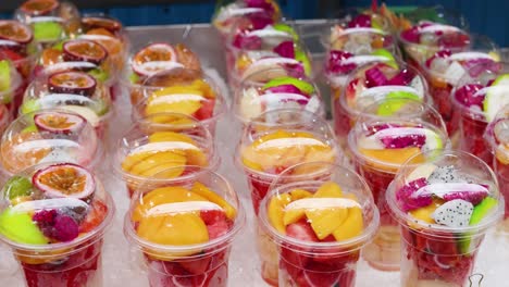 vibrant fruit cups displayed at a street market