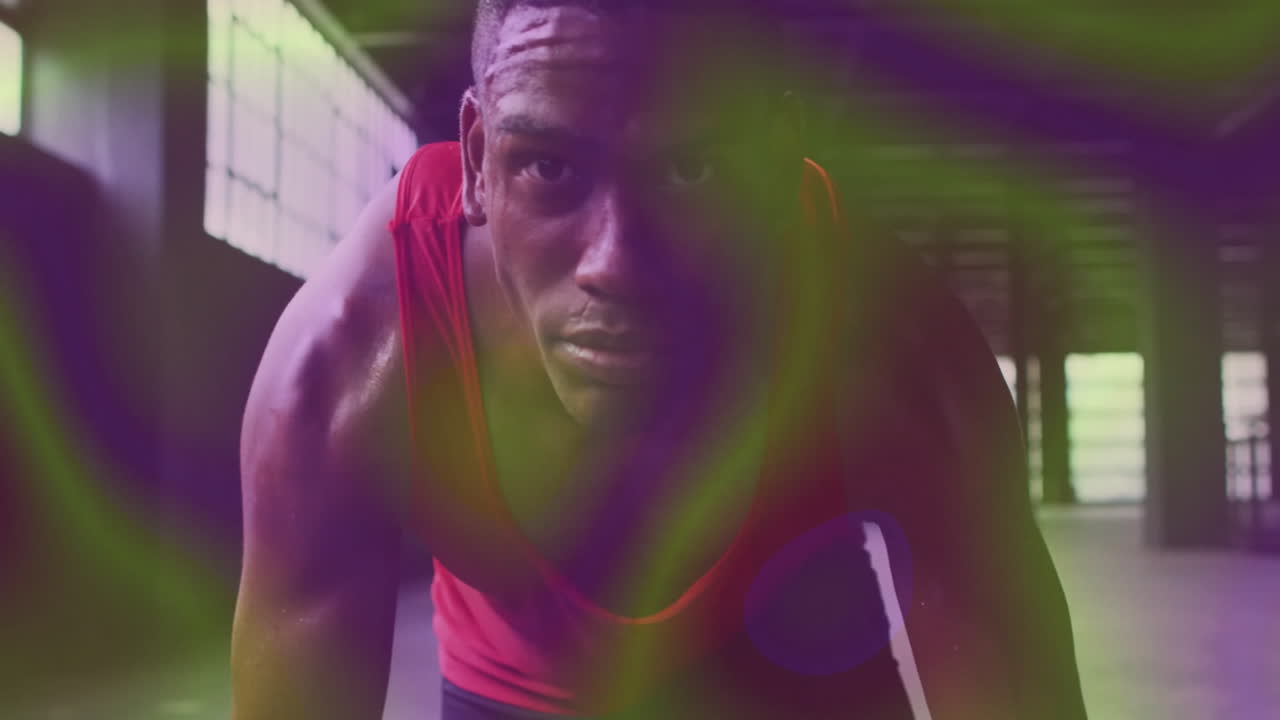 In animation, athlete in red tank top preparing to sprint with colorful lights