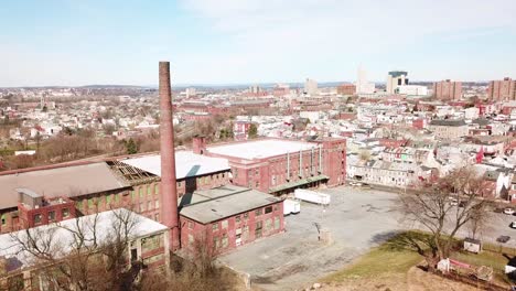 aerial over an abandoned american factory with smokestack near reading pennsylvania 1