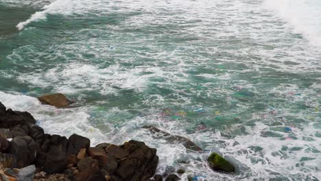 Sea-coast-polluted-by-plastic-litter-floating-on-waves-near-tourist-resort