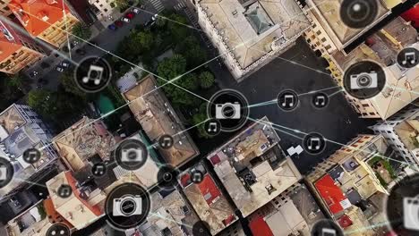 animation of icons connected with lines over aerial view of buildings