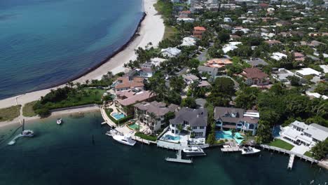 beautiful housing along the waters of florida with swimming pools and yachts from an aerial drone shot over the town