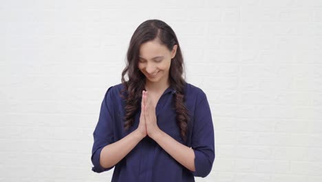 indian girl greeting guests at a event