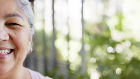 portrait of happy biracial senior woman in sunny outdoors, copy space