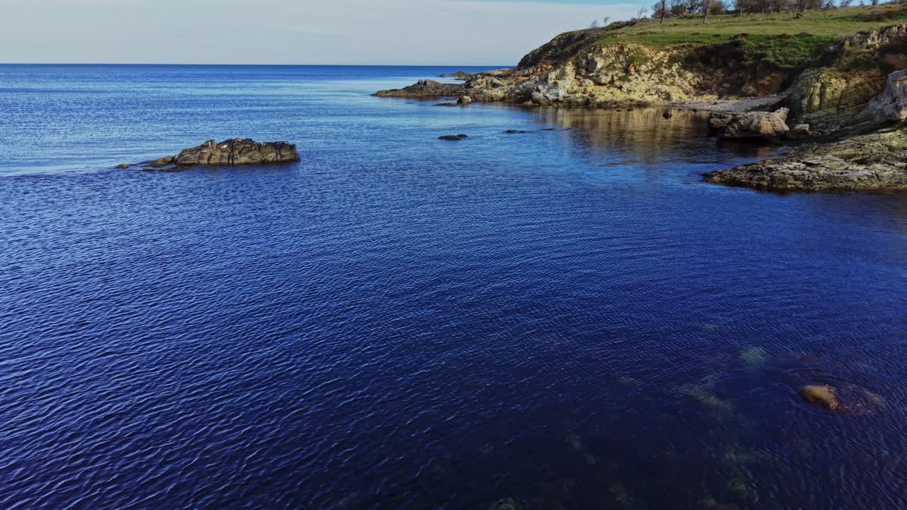Vista aerea di un mare calmo e di una costa rocciosa in un paesaggio costiero